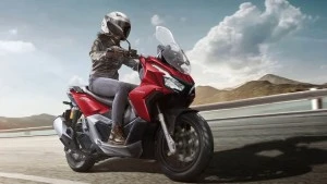 Woman riding on Honda ADV 160 Motorcycle